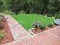 This is a shot of looking south while standing on the patio, the oven is at the west end of the brick patio, the grassy area provides more seating options for entertaining.  There is a sharp drop off just beyond that grass into woods (a fabulous supply of dry fuel for the oven!)