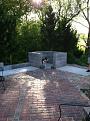 The concrete slab for the oven portion poured, the brick laid around it to tie it visually to the existing patio, and the stand built up and ready for angle iron supports.