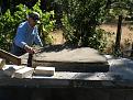 Brother-in-law Mark, preparing and leveling the damp builders sand for the hearth bricks.