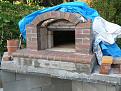 Used a curved piece of scrap wood to set both the front and back arches. Back arch was made of firebrick, front arch was standard, solid bricks.