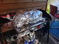 Pig resting on three burner camp stove.