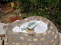 A platform with bags of sand and plastic cover to support the bricks.