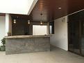 Oven sits diagonally in the back left corner in this photo. The bar counter still needs stonework.