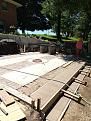 new patio area outside house.  Oven base seen across patio.